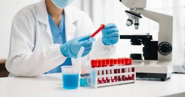 Scientist mixing chemical liquids in the chemistry lab. Researcher working in the chemical laboratory