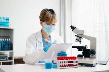 Scientist mixing chemical liquids in the chemistry lab. Researcher working in the chemical laboratory
