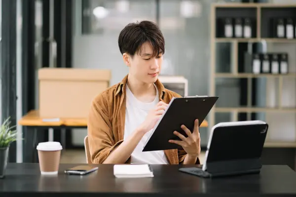 business man executive manager looking at digital tablet watching online webinar training or having virtual meeting video conference doing market research working in office.