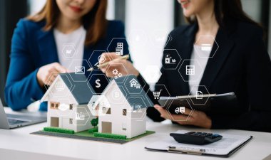 Salesman Hands On House Model , Small Toy House Small Mortgage Property insurance and concepts real estate in office