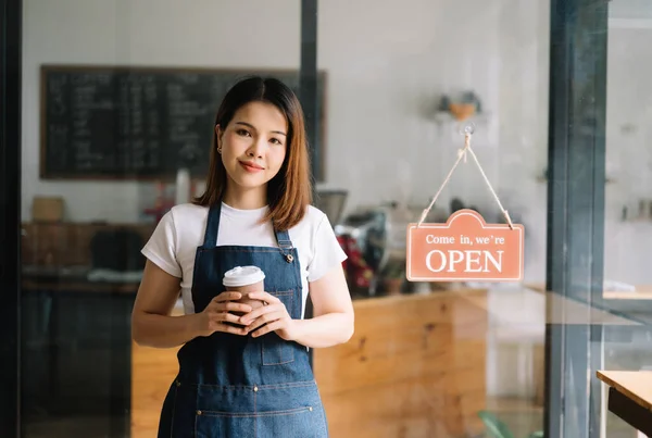 Startup successful small business owner sme woman standing in cafe restaurant. woman barista cafe owner.