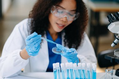 Modern tıbbi araştırma laboratuvarı. Kadın bilim adamı mikro pipetlerle çalışıyor biyokimyasal örnekleri analiz ediyor, tıp için ileri bilim kimya laboratuvarı.