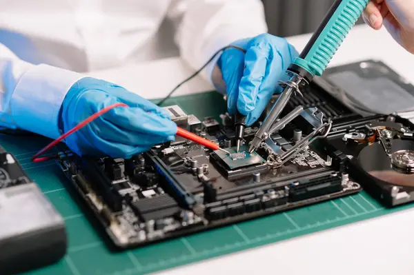 The technician repairing the motherboard in the lab with copy space. the concept of computer hardware, electronic, repairing, upgrade blue effect