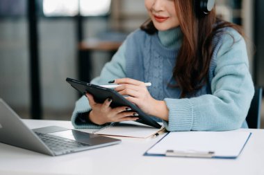 İnternette bilgi aramak için dizüstü bilgisayar kullanan kız öğrenci.