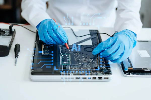 Electronics technician measuring and testing Circuit Board, repair and maintenance concepts.Worker uses a voltage meter to check digital device