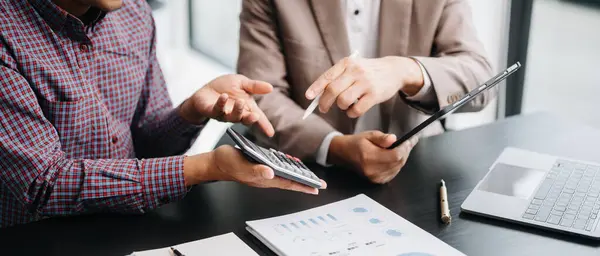 stock image Businessmen analyzing financial task using calculator and tablet pc. Wealth management concept