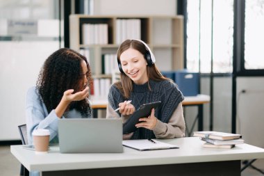 Okul projesinde birlikte çalışan iki çekici genç kız üniversite öğrencisi.