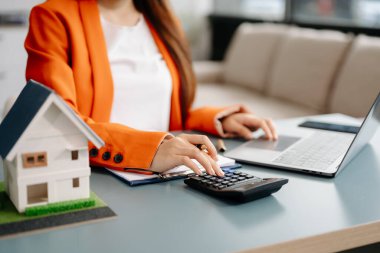 Considering buying a home, investing in real estate. Broker signs a sales agreement. agent, lease agreement, successful deal 