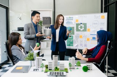 İş adamlarının şirket ofisinde rüzgar enerjisi hakkında görüşleri var. İş ekibi yel değirmenleri ve alternatif yeşil enerji hakkında konuşuyor. Ofiste yönetici toplantısı. 