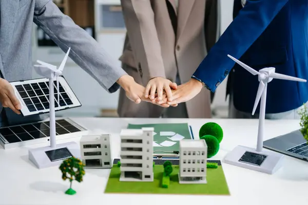 stock image business team planning and discussing on recycle reduce reuse policy in office meeting room. Green business company and Solar Energy Environment city Concept