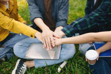 Genç öğrenciler sabah kampüs parkında el ele tutuşuyorlar.