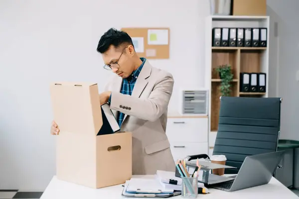 stock image Asian office worker taking personal stuff while leaving job in modern office, changing or company