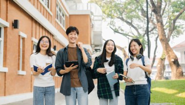 Üniversite öğrencileri sabahları kampüs parkında dijital tabletle çalışıyorlar. 