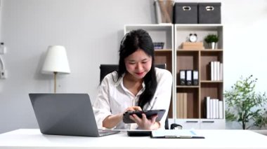 Ofisteki bir ofiste matematik finansmanı için tablet bilgisayar kullanan bir iş kadını