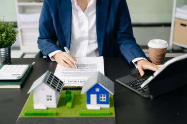 Emlak komisyoncusu ev modelini sunar. İşadamı, konut kredisi teklifiyle ilgili müşteriye danıştı 