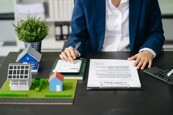 Stock image Real estate broker agent presenting  home model. Businessman consult to customer of concerning mortgage loan offer in office 