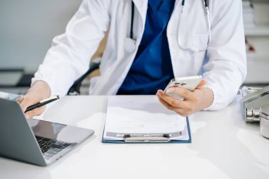 Medical technology concept. Doctor working with mobile phone and stethoscope in modern office