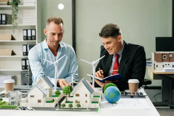 stock image Business team people planning and discussing on recycle reduce reuse policy symbol in office meeting room. Green business company and Solar Energy Environment city Concept.