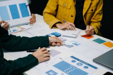 UI müteahhitlerinin ofiste akıllı telefonlarıyla projelerine beyin fırtınası yapmalarını yakından izliyoruz. Yaratıcı dijital geliştirme ajansı