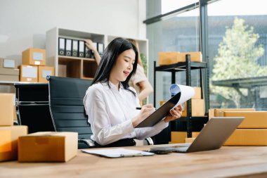 Küçük işletmeler kuran KOBİ sahipleri çevrimiçi siparişleri kontrol ediyor ve ev bilgisayarlarında çalışan ürünleri satıyorlar 