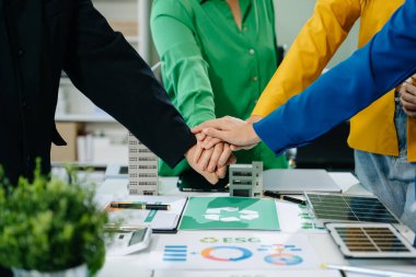 Geri dönüşüm planı ve tartışması ofis toplantı odasında politika azaltma sembolü. İş arkadaşları el ele tutuşuyor. Yeşil iş şirketi ve Güneş Enerjisi Çevre Kenti Kavramı