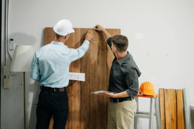 Mimarlar ve tasarımcılar modeller ve planlar üzerinde işbirliği yapıyorlar, yenilikçi yapılar üzerinde beyin fırtınası yapıyorlar ve modern bir ofiste kentsel gelişim planlıyorlar..