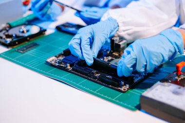 Laboratuvar önlüklü işçiler elektronik montaj ve yüksek teknolojili RAM kurulumu yapıyorlar. Gelişmiş teknoloji ve bilgisayar mühendisliği kavramlarını sergilemek için ideal.