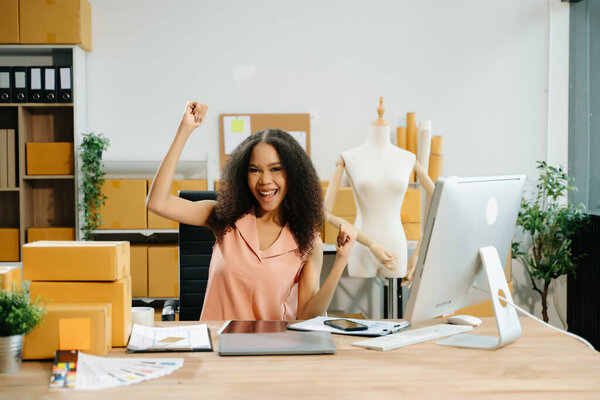 African american fashion designer at desk, working in studio and gesturing hands