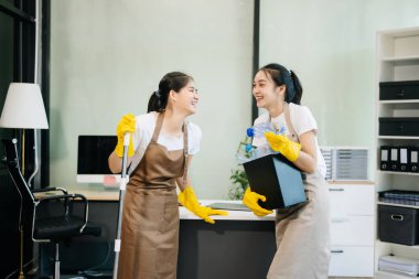 Verimli ve profesyonel temizlikçiler odayı temizliyor.