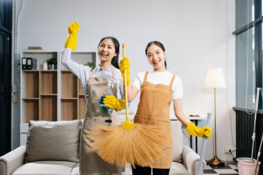 Efficient and professional housekeepers cleaning the room clipart