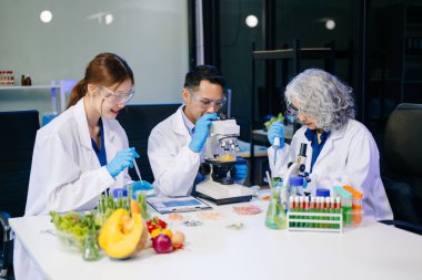 Dynamic scene of food scientists using microscopes and pipettes in a lab, analyzing samples, emphasizing innovation, collaboration, and food safety research clipart