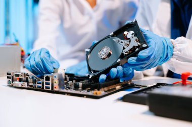 The technician repairing the motherboard in the workshop  clipart