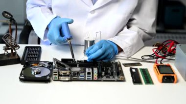 Teknisyen atölyedeki ana kartı tamir ediyor. 