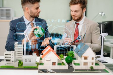 Uzmanlar ev modelleri, rüzgar türbinleri ve güneş panelleri ile yenilenebilir enerji çözümleri üzerinde işbirliği yaparak, dijital tablet bilgisayar, yeşil enerji kavramı ve yeşil tablet kullanarak yeşil tasarım ve yenilikleri vurguluyorlar. 