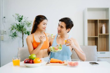 Spor ikilisi sağlıklı yaşamı taze salata, meyve suyu ve meyve suyuyla kutluyor. Sağlığın, beslenmenin ve aktif yaşam tarzının mükemmel dengesi.