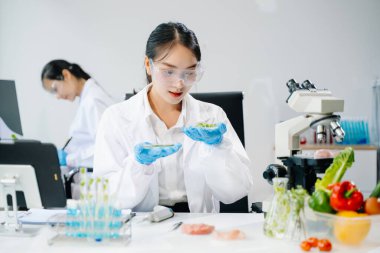 Laboratuvar bilimcileri olarak gıda bilimi, gelişmiş teknoloji ve hassas ekipmanlar kullanarak sebzeleri güvenlik ve kalite için test edip analiz ediyor..