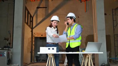 İki genç Asyalı mimar projeyi tartışıyor