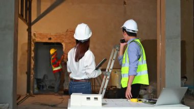 İki genç Asyalı mimar projeyi tartışıyor