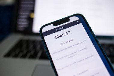 close-up of a person's hand holding a smartphone with a pen on a screen