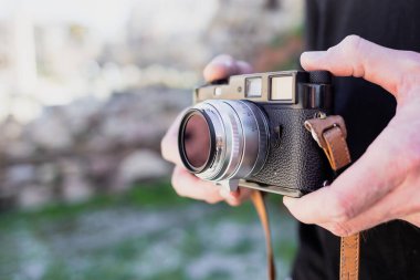 a man photographing a camera on a tripod