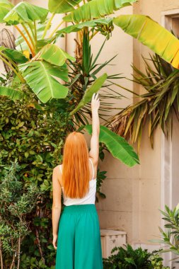 young beautiful woman in a green dress in the garden