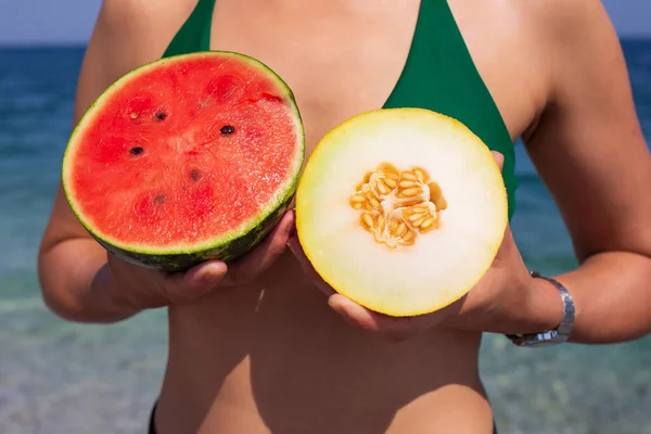 stock image woman with piece of watermelon on the beach