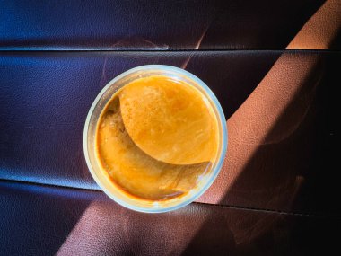 Top view of Coffee with milk in glass,hot drink,reflection of sunlight shining around,blurry light around. clipart