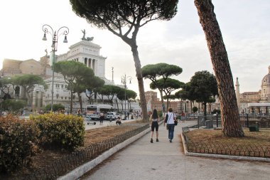 Rome, Italy - September 14 2022: Via dei Fori Imperiali Road in Rome, Italy with Walking Tourists, Traffic and Monument of Vittorio Emanuele II. clipart