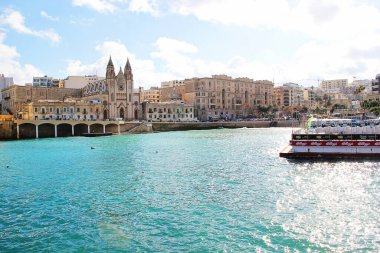 San Giljan, Malta - December 20 2022: Malta and St. Julian Bay with Carmelite Church clipart