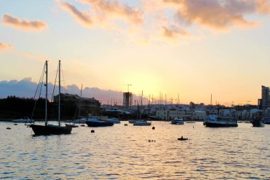 Valletta, Malta - December 20 2022: Malta Island and Gzira Town Landscape at Sunset with Sailboats clipart