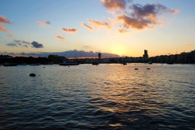 Valletta, Malta - December 20 2022: Malta Island and Gzira Town Landscape at Sunset with Sailboats clipart