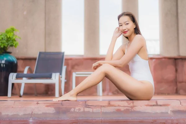美しい若いアジアの女性がホテルやリゾートで屋外スイミングプールの周りの笑顔のレジャーをリラックス — ストック写真