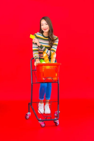 Portrait Beautiful Young Asian Woman Grocery Basket Supermarket Red Isolated — Stock Photo, Image