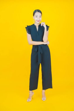 Portre güzel Asyalı kadın gülümsüyor. Renkli arka planda hareket var.